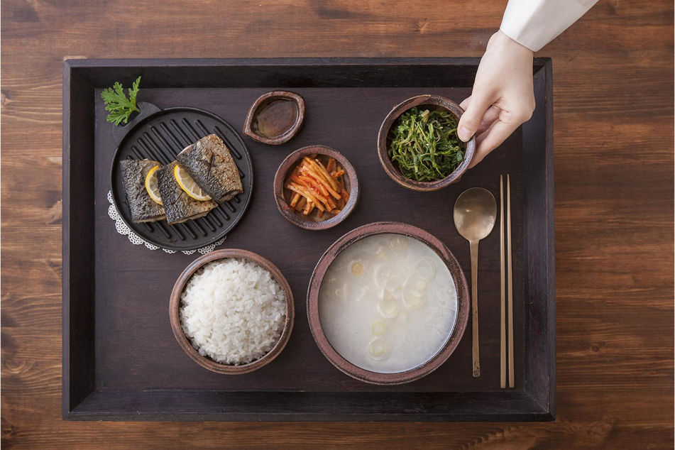 A bowl of bibimbap A bowl of bibimbap with various ingredients and a set of spoons and chopsticks