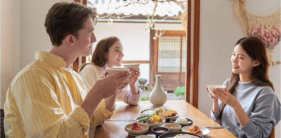 A picture of a happy meal Two women and two men having a meal and chatting happily